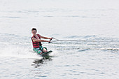 Teenager waterskiing