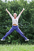 Woman jumping on grass