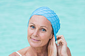 Woman in a pool wearing a bathing cap