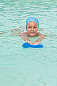 Woman in a pool wearing a bathing cap