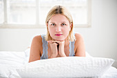 Young woman lying in bed