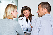 Doctor talking with a couple during consultation