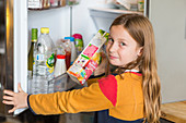 Child in front of a fridge