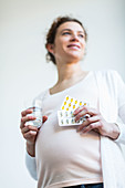 Pregnant woman taking gelatine capsules
