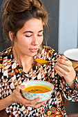 Woman eating a soup