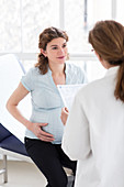 Doctor checking analysis results of pregnant woman