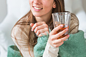 Woman drinking hot beverage