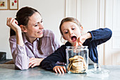 6 year-old girl reaching into a jar of cookies