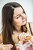 Teenage girl brushing her hair