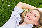 Woman lying on grass smiling