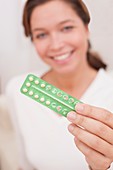 Woman holding contraceptive pills