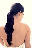 Woman with long brown hair in pony tail