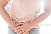 Woman clutching stomach in pain