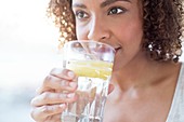Mid adult woman drinking water