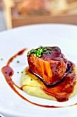 Braised Iberico pork belly with gravy on a bed of mashed potato