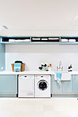 Washroom with light blue shelves and cupboard fronts