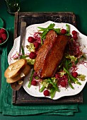 Goose breast with a red cabbage sprout and mange tout salad and raspberries