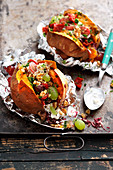 Baked sweet potatoes filled with goats cheese and grapes (Turkey)