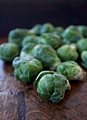 A pile of brussels sprouts on a wooden table