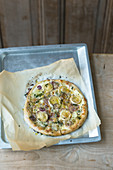 A rustic cheese pizza with red onions