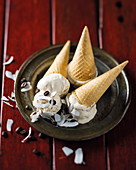 Cones filled with chai and coffee ice cream and decorated with coconut shavings