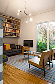 Bookcase above sofa in retro living room