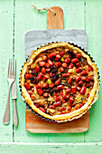 Puff pastry tart with frankfurter sausages and dried tomatoes