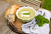 Leek and potato soup with cream, mint and crusty baguette