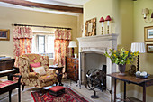 Armchair and grand piano in front of fireplace in rustic living room