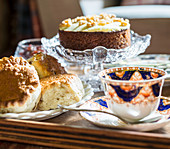 Pastries, cake and elegant teacup and saucer on table