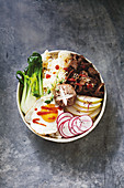 A lunch bowl with Korean bulgogi, vegetables, rice and fried egg (Korea)