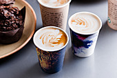 Flat whites in two paper cups (Australia)
