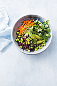 Black rice salad with edamame beans, gherkins, carrots and corriander