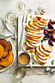 Sliced turkey with rum butter and roasted pumpkin for Christmas