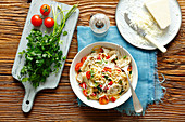 Spaghetti with champignones and oyster mushrooms, cherry tomatoes and chili