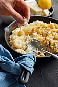 Risotto with baked cauliflower and lemon peel in a pan