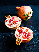 Fresh sliced organic pomegranate on a dark background