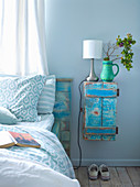 Vintage closets in turquoise as bedside table next to bed with wooden headboard in matching color