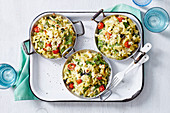 Macaroni and cheese in three small pans