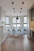 Kitchen-dining room with dining table in window bay