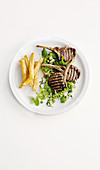 Grilled lamb chops with pea puree and french fries