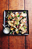 Grilled potatoes with bacon and capers