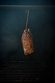 Smoked goose breast on a meat hook