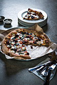 Pizza with olives and goat cheese