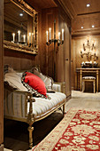 Baroque bench in opulent, candlelit hallway with wood panelling