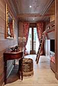 Opulent bedroom with bunk beds and wood panelling