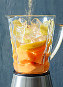 Ingredients for mango and melon daiquiri in a blender