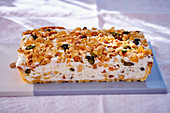 Ice cream slices with nuts, seeds, and candied fruits