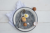 Cutlery, painted Easter eggs and egg shells on vintage plate