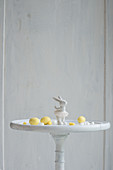 Easter bunny ornament and marzipan eggs on white table